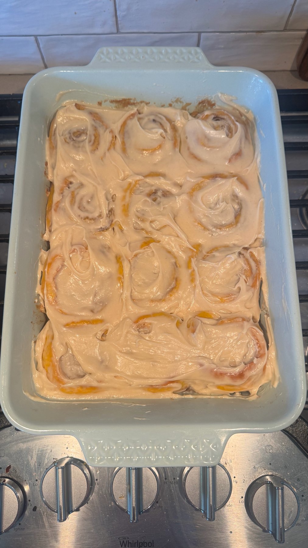A pan of frosted brown butter pumpkin cinnamon rolls